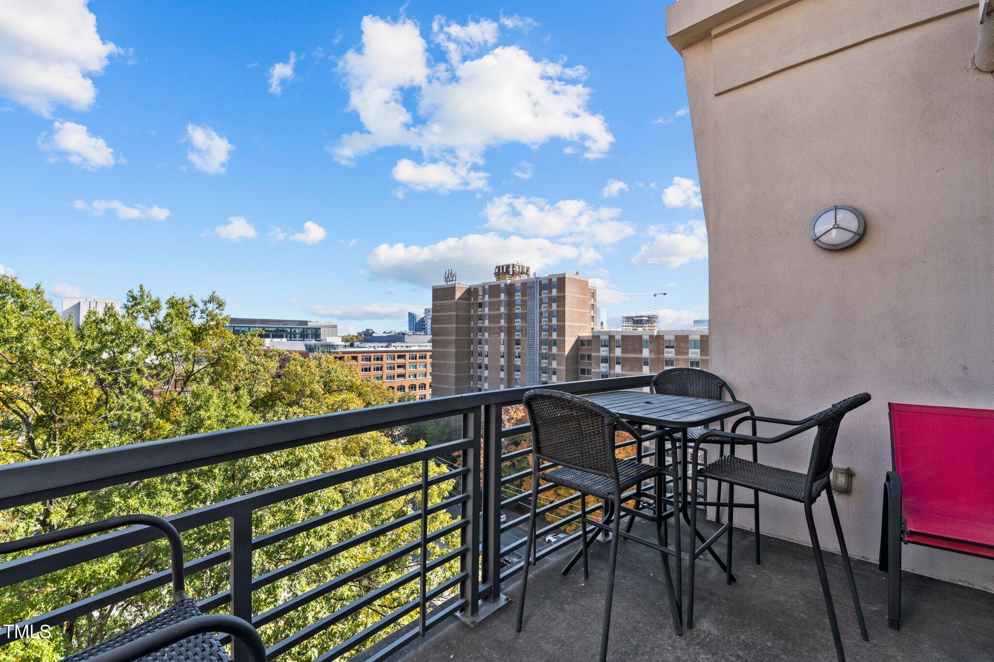 618 North Boylan Avenue, Unit 810 Raleigh, NC 27603 - Photo 15 of 57 a view of a chairs and table in a balcony
