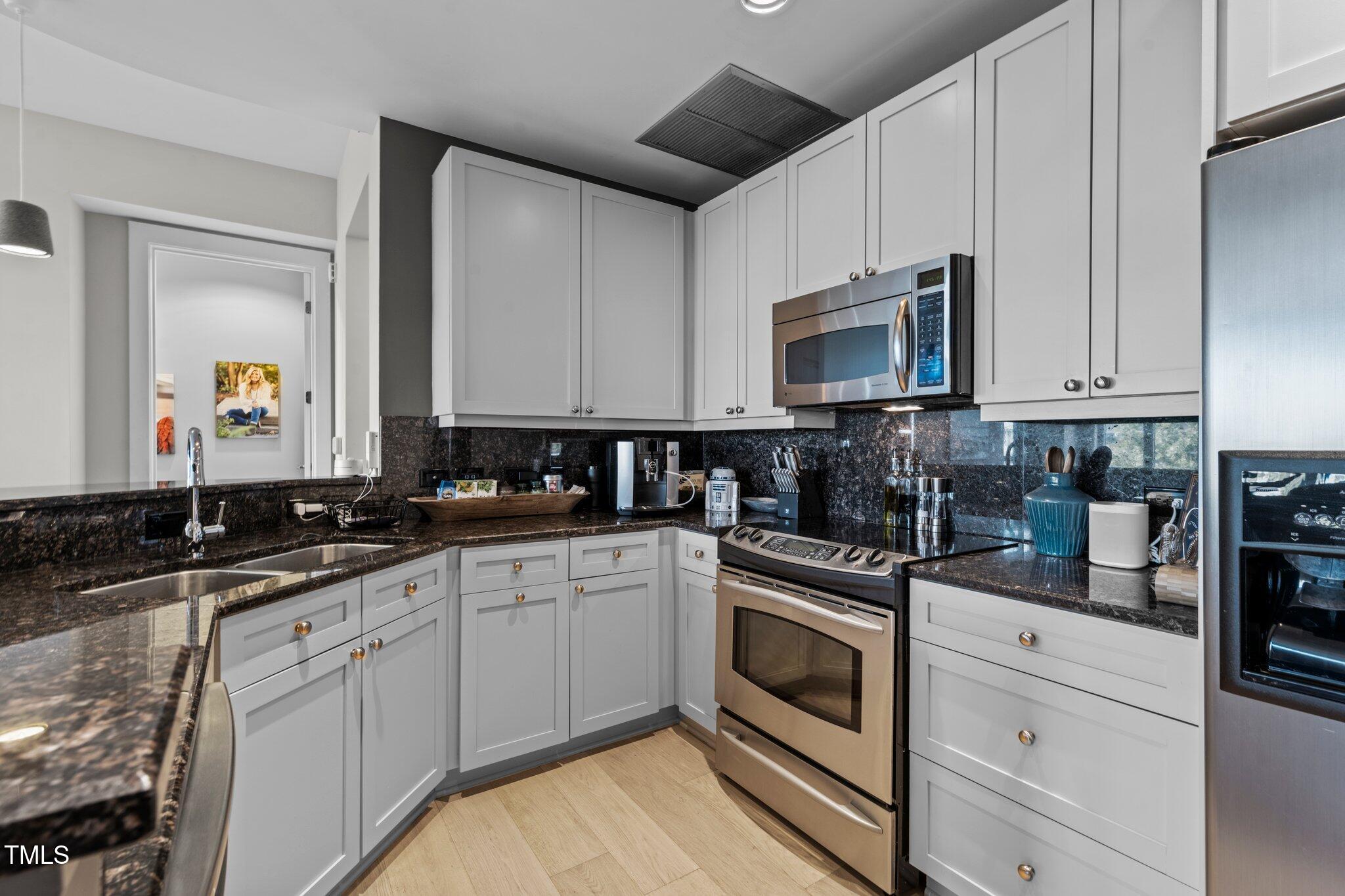 618 North Boylan Avenue, Unit 810 Raleigh, NC 27603 - Photo 18 of 57 a kitchen with a sink stove and cabinets