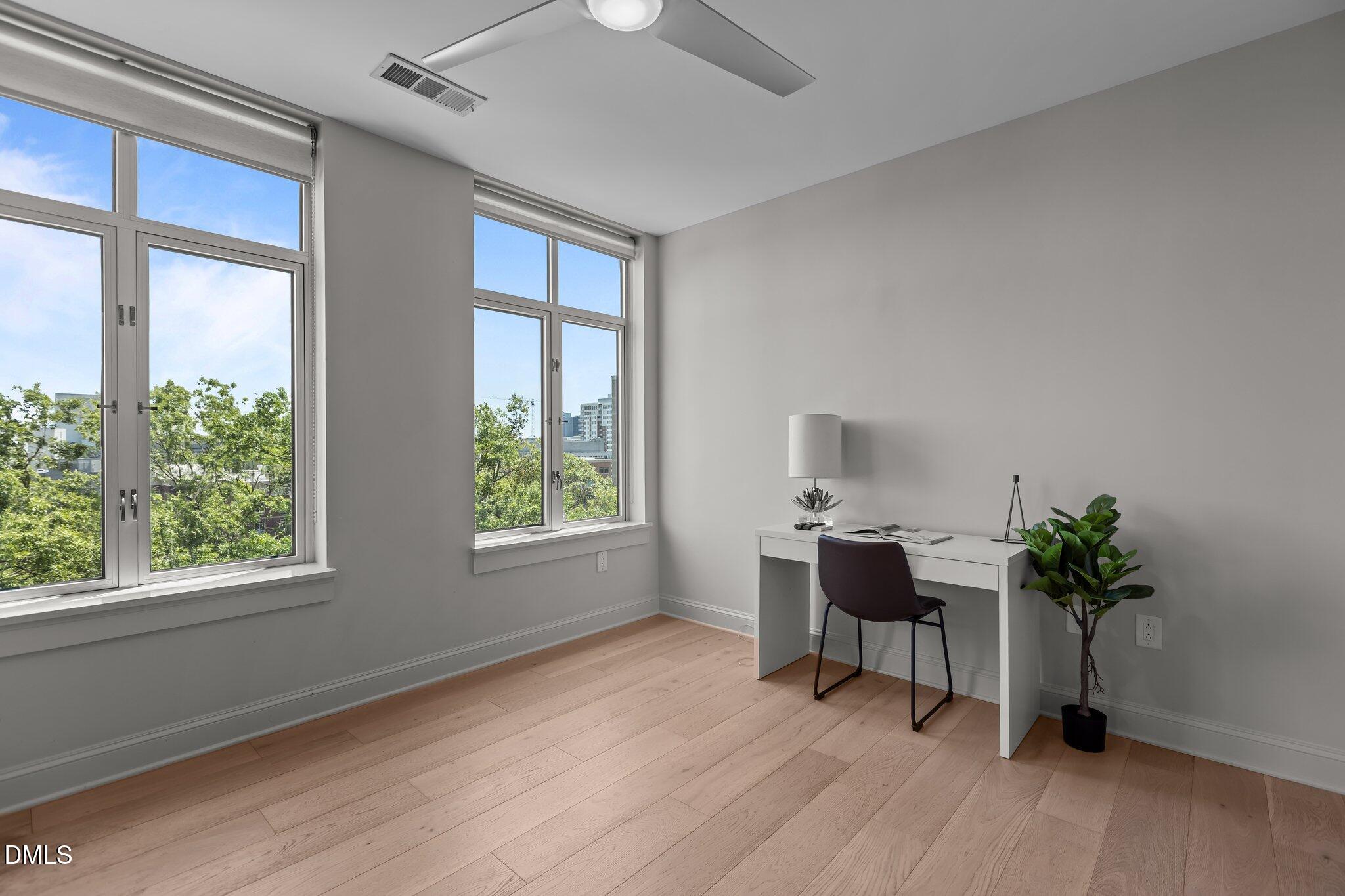 618 North Boylan Avenue, Unit 810 Raleigh, NC 27603 - Photo 35 of 57 a workspace with furniture window and wooden floor