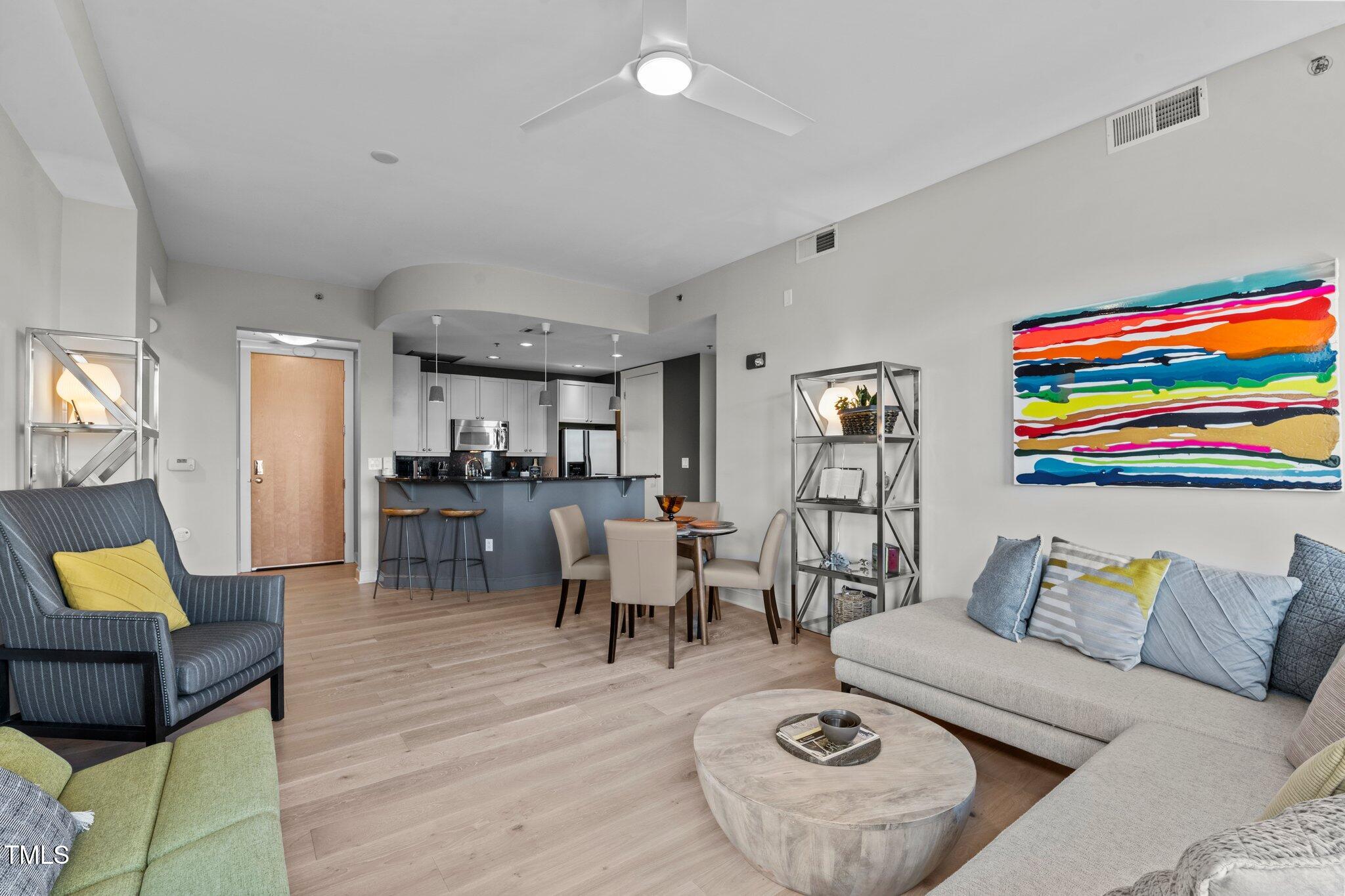 618 North Boylan Avenue, Unit 810 Raleigh, NC 27603 - Photo 7 of 57 a living room with furniture and wooden floor