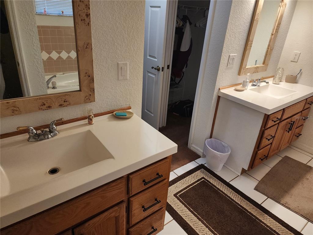 11759 Oswalt Road Clermont, FL 34711 - Photo 13 of 24 a bathroom with a sink and a mirror