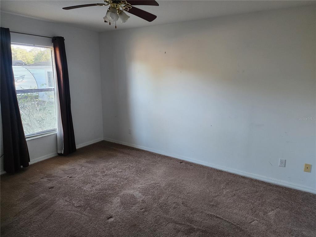 11759 Oswalt Road Clermont, FL 34711 - Photo 18 of 24 an empty room with a window
