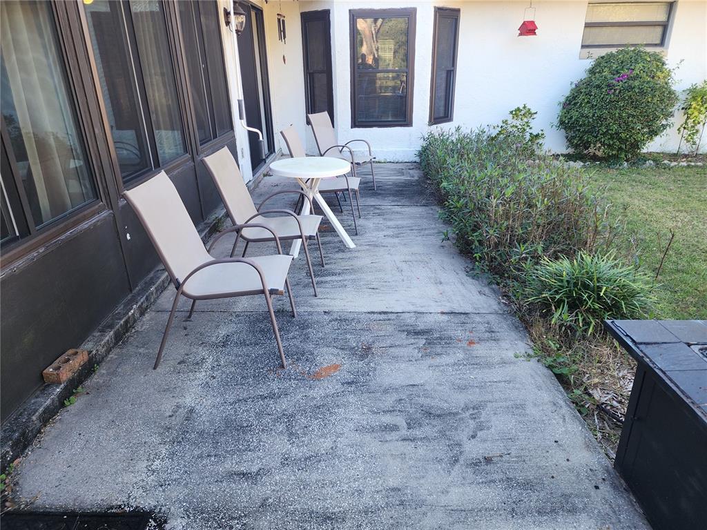 11759 Oswalt Road Clermont, FL 34711 - Photo 22 of 24 a view of a chairs and table in the backyard