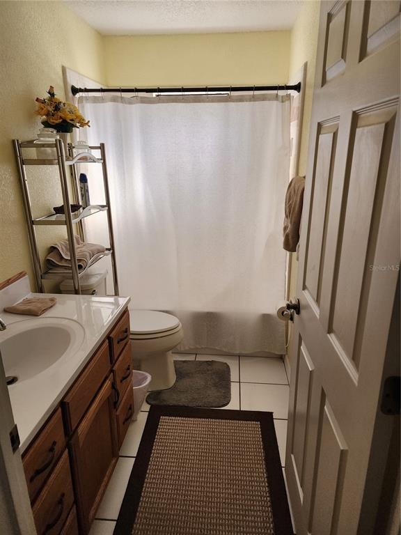 11759 Oswalt Road Clermont, FL 34711 - Photo 7 of 24 a bathroom with a sink a toilet a mirror and shower