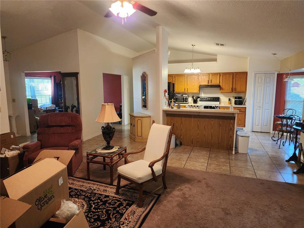 11759 Oswalt Road Clermont, FL 34711 - Photo 8 of 24 a living room with furniture dining table and a stove
