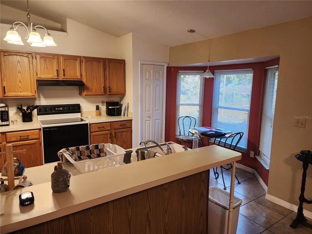 11759 Oswalt Road Clermont, FL 34711 - Photo 10 of 24 a kitchen with a sink appliances and cabinets