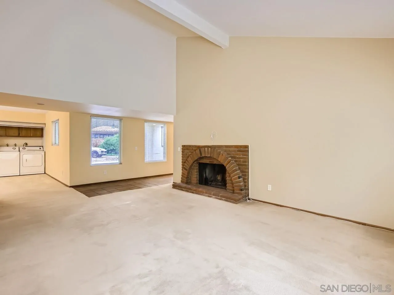 124 Candy Lane Encinitas, CA 92024 - Photo 11 of 27 a view of an empty room with a fireplace and a window