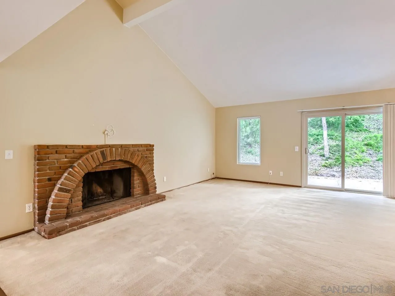 124 Candy Lane Encinitas, CA 92024 - Photo 5 of 27 an empty room with windows and fireplace