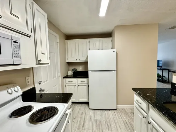 a kitchen with stainless steel appliances a refrigerator sink and cabinets