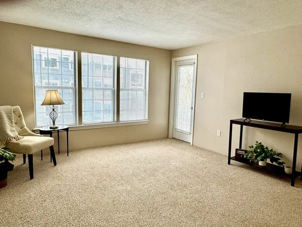 a view of a livingroom with furniture and a flat screen tv