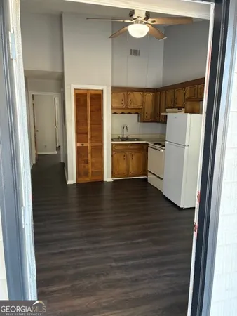 a view of a kitchen with a sink and a refrigerator