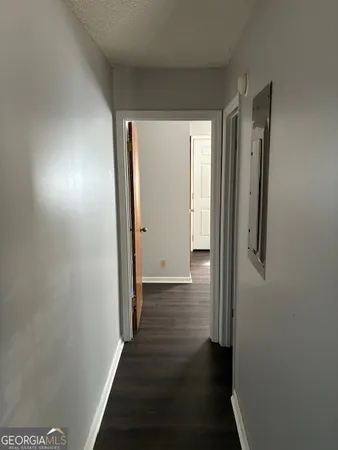 a view of a hallway with wooden floor