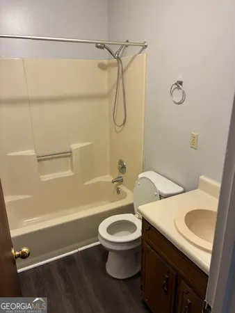 a bathroom with a granite countertop toilet sink and shower