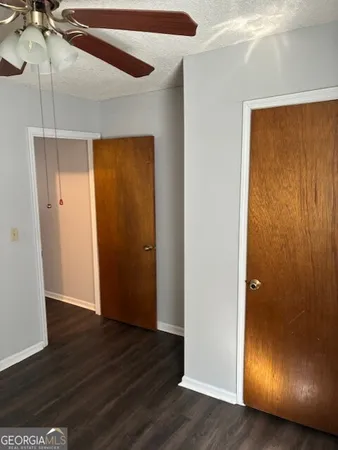 an empty room with wooden floor and entrance