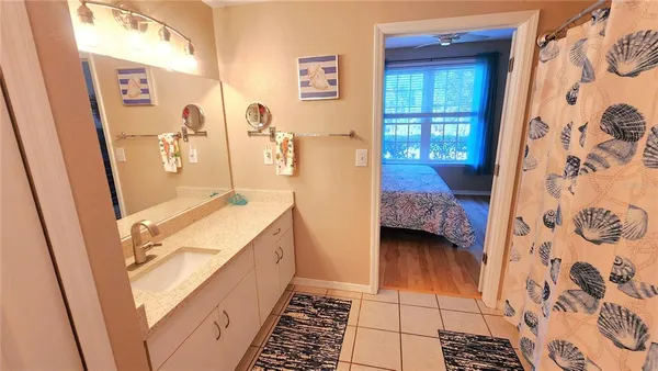 a bathroom with a double vanity sink and shower