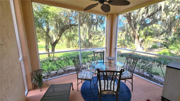 a view of a porch with dining table and chairs