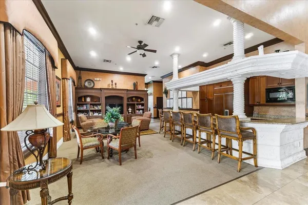 a living room with fireplace furniture and a large window
