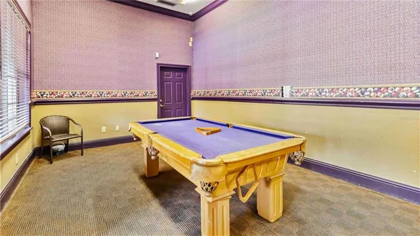 a bath room with a table and chairs