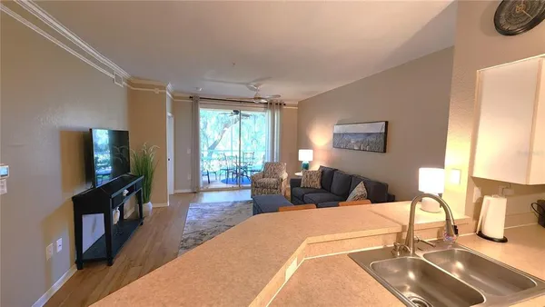 a bedroom with a bed a flat screen tv and a large window with the garden view