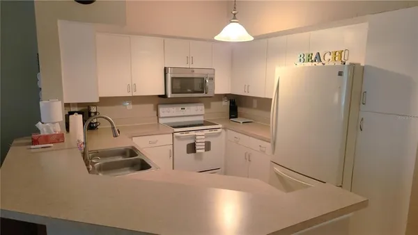 a kitchen with a sink a stove and refrigerator