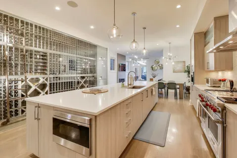 a kitchen with stainless steel appliances a sink stove and cabinets