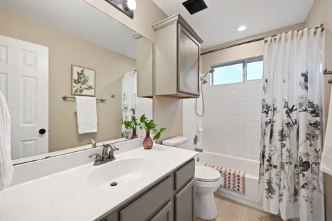a bathroom with a sink toilet and shower
