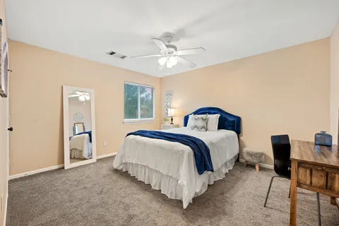 a bedroom with a bed and a chandelier