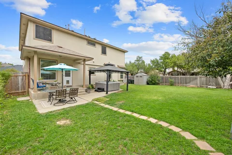 a view of a house with backyard sitting area and garden