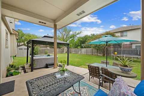 a view of a porch with furniture and garden