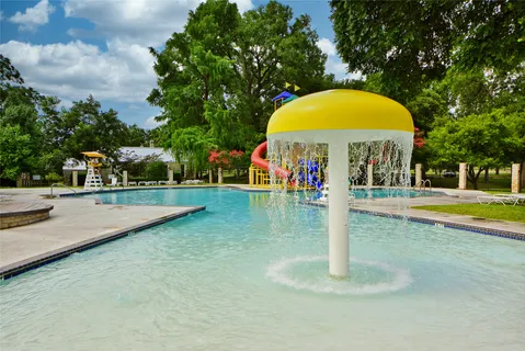 a view of swimming pool with a garden and deck