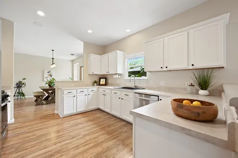 a kitchen with appliances a sink and cabinets