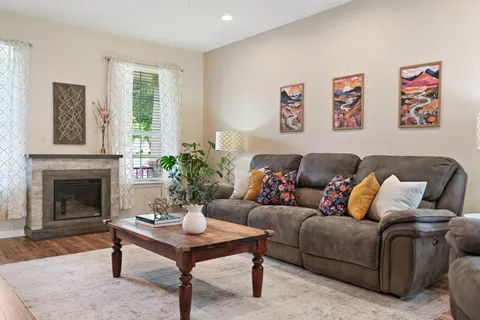 a living room with furniture a table and a fireplace