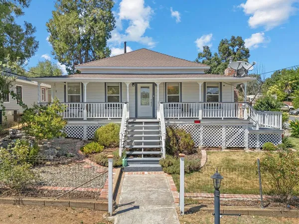 a front view of a house with garden