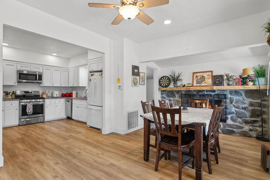 18110 4th Avenue Jamestown, CA 95327 - Photo 14 of 37 a kitchen with stainless steel appliances granite countertop a dining table chairs refrigerator and microwave