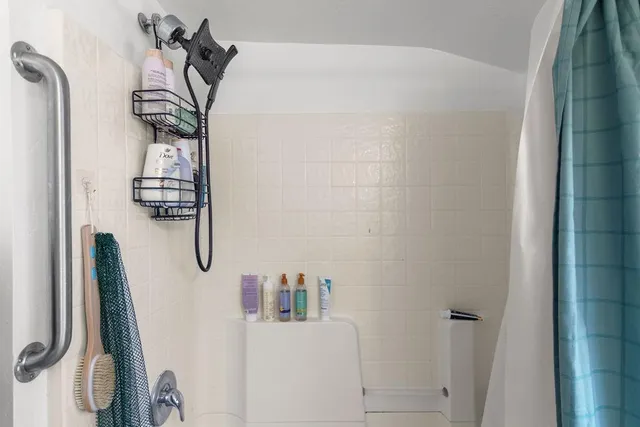 a bathroom with a granite countertop sink two mirror and a vanity