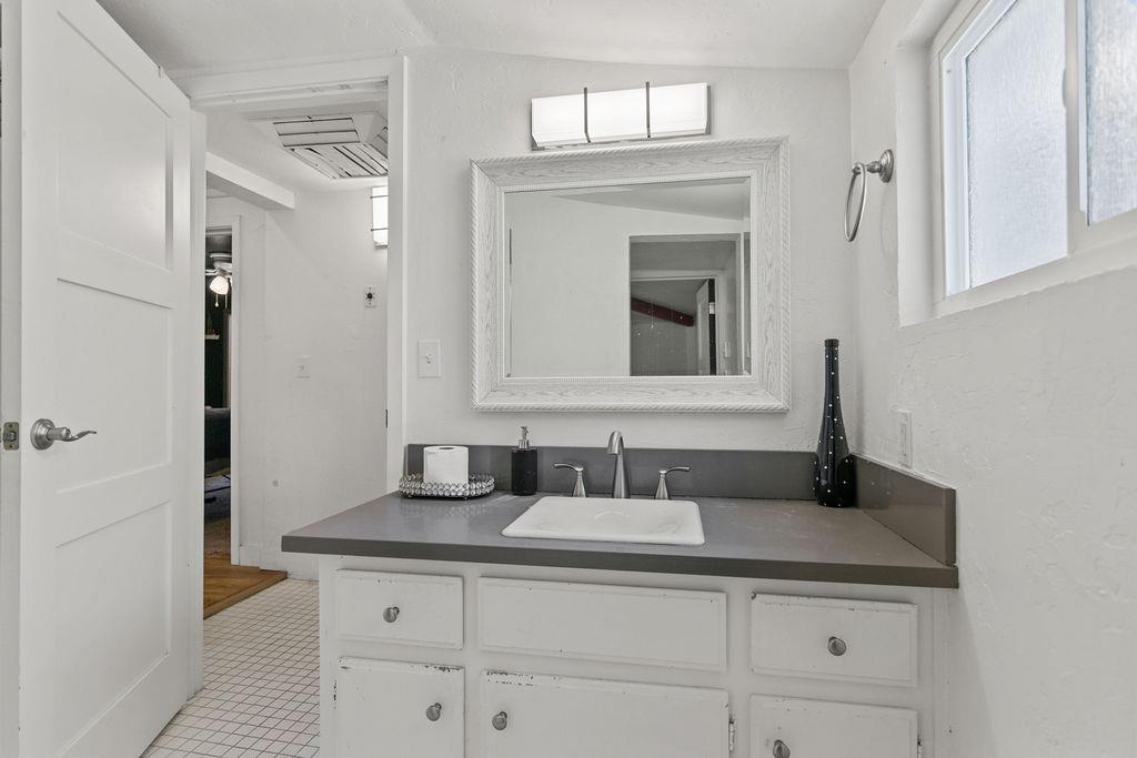 18110 4th Avenue Jamestown, CA 95327 - Photo 22 of 37 a bathroom with a granite countertop sink two mirror and a vanity