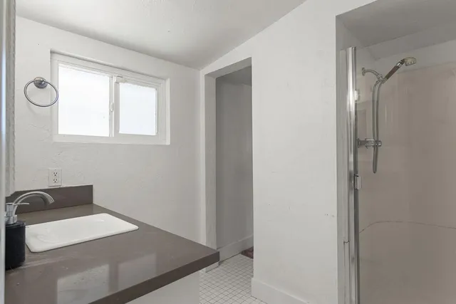 a bed room with a bed window and a chandelier