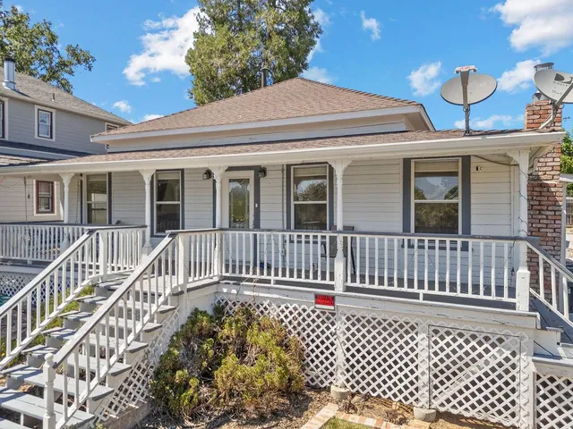 a front view of a house with a fence