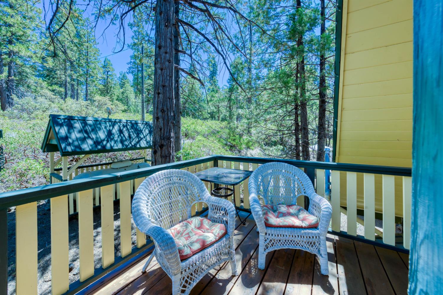 42025 Tollhouse Road Shaver Lake, CA 93664 - Photo 49 of 64 a view of balcony with wooden floor and outdoor seating