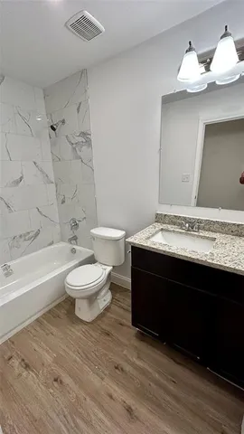 a bathroom with a sink a toilet and a bathtub