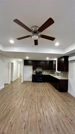 a view of kitchen with refrigerator and window