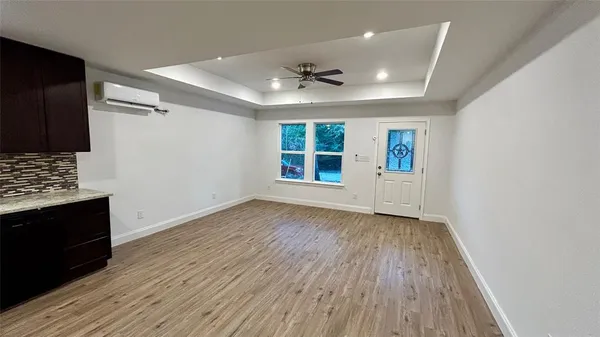 wooden floor in an empty room with a window