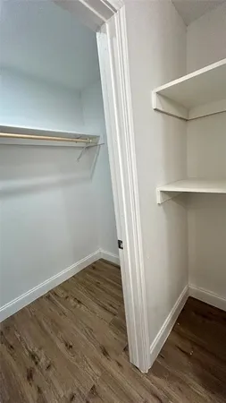 a view of a room with wooden floor