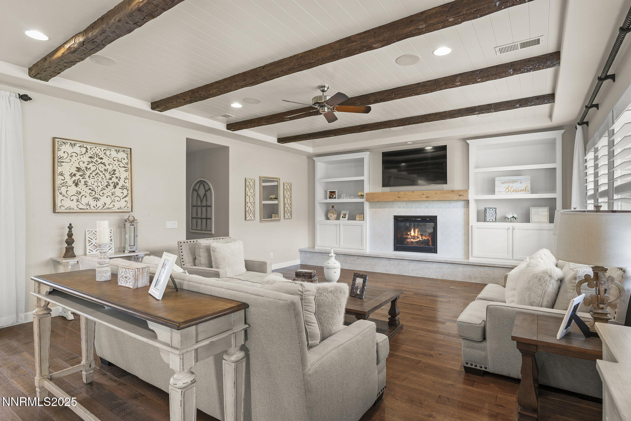 9890 Kerrydale Court Reno, NV 89521 - Photo 15 of 48 a living room with furniture a fireplace and a flat screen tv