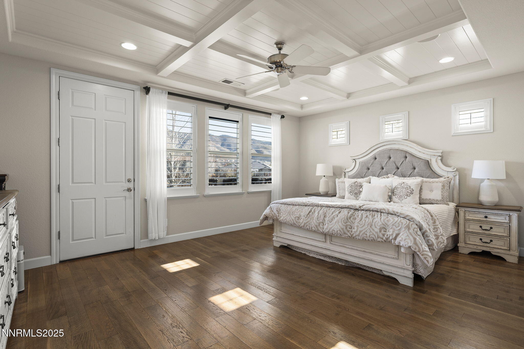9890 Kerrydale Court Reno, NV 89521 - Photo 21 of 48 a spacious bedroom with a large bed chandelier and a window