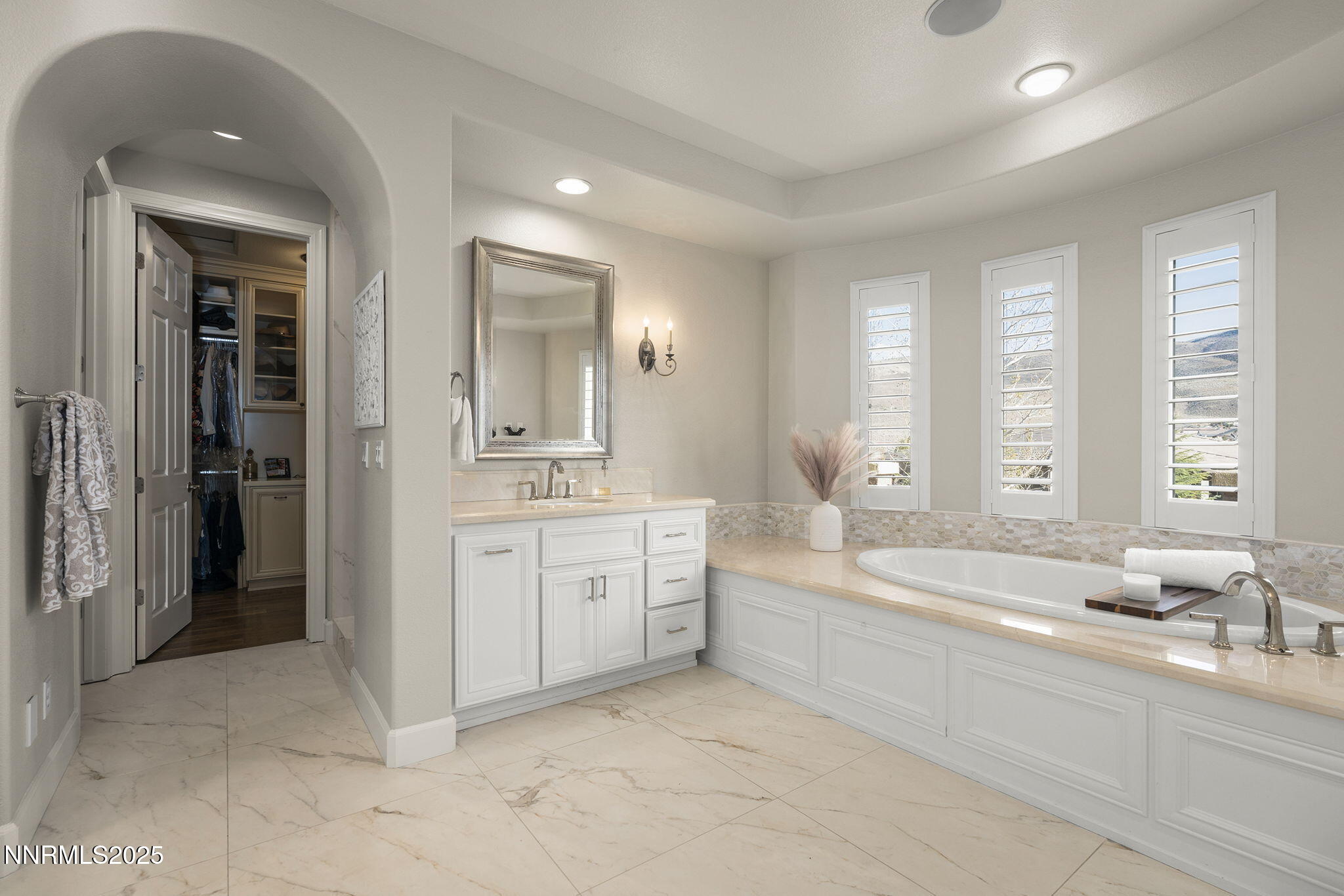 9890 Kerrydale Court Reno, NV 89521 - Photo 25 of 48 a spacious en suite bathroom with a double vanity sink a mirror and a bathtub