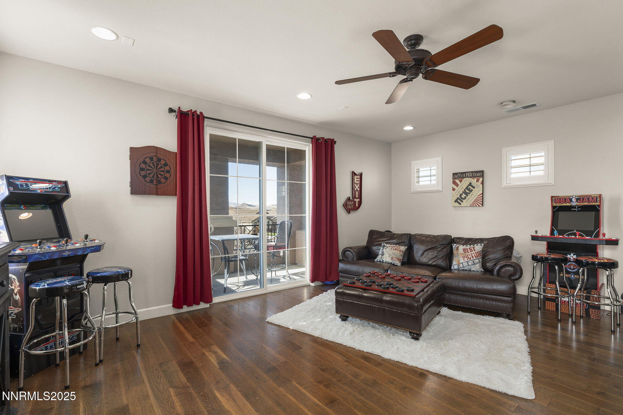 9890 Kerrydale Court Reno, NV 89521 - Photo 31 of 48 a living room with furniture and a flat screen tv with wooden floor