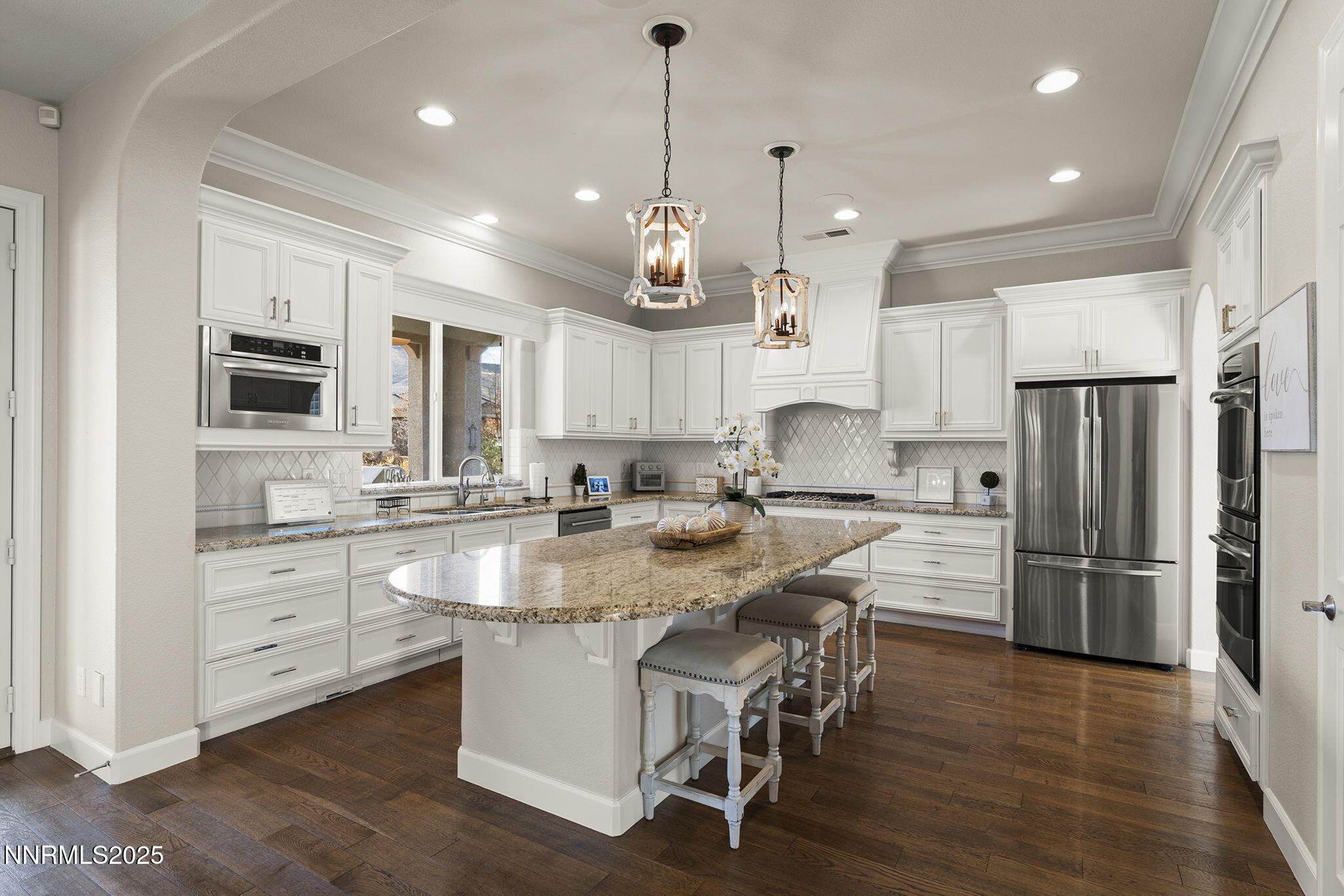 9890 Kerrydale Court Reno, NV 89521 - Photo 10 of 48 a kitchen with kitchen island granite countertop a sink a center island and stainless steel appliances