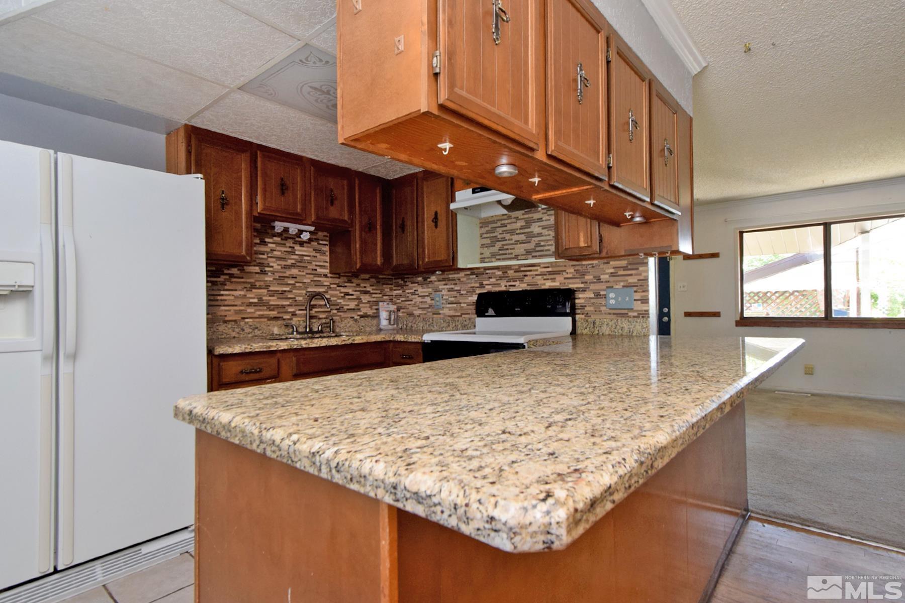 1279 Ebbetts Drive Reno, NV 89503 - Photo 15 of 37 a view of a kitchen with stainless steel appliances granite countertop a sink and a counter top space