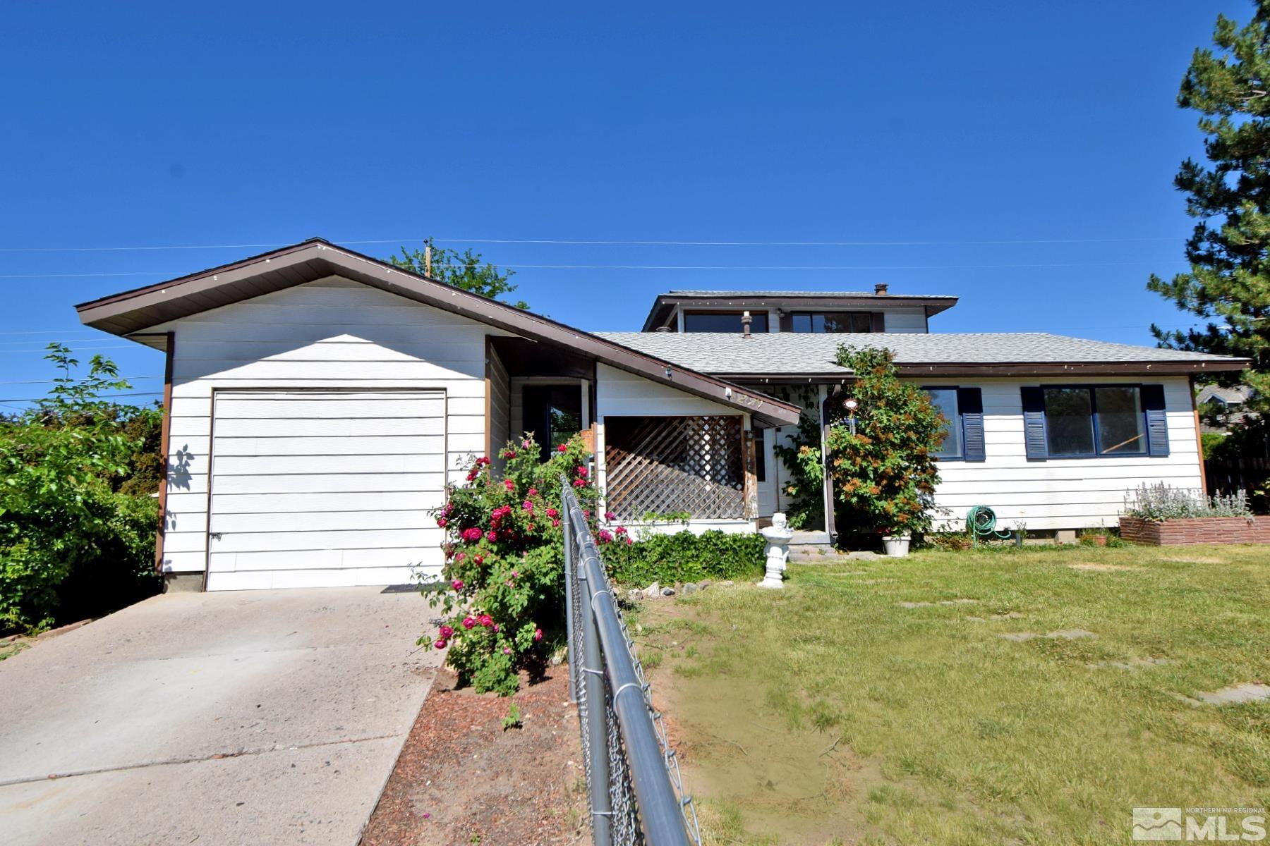 1279 Ebbetts Drive Reno, NV 89503 - Photo 2 of 37 a front view of a house with a yard